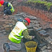 Excavating the north wall fireplace.