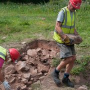 Removing demolition debris at the north end of the trench.