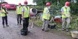 Learning how to mix lime mortar.