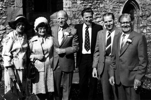 A group of people outside a church door.