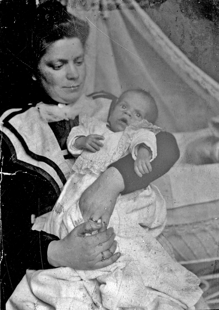 a mother holds a baby in her arms